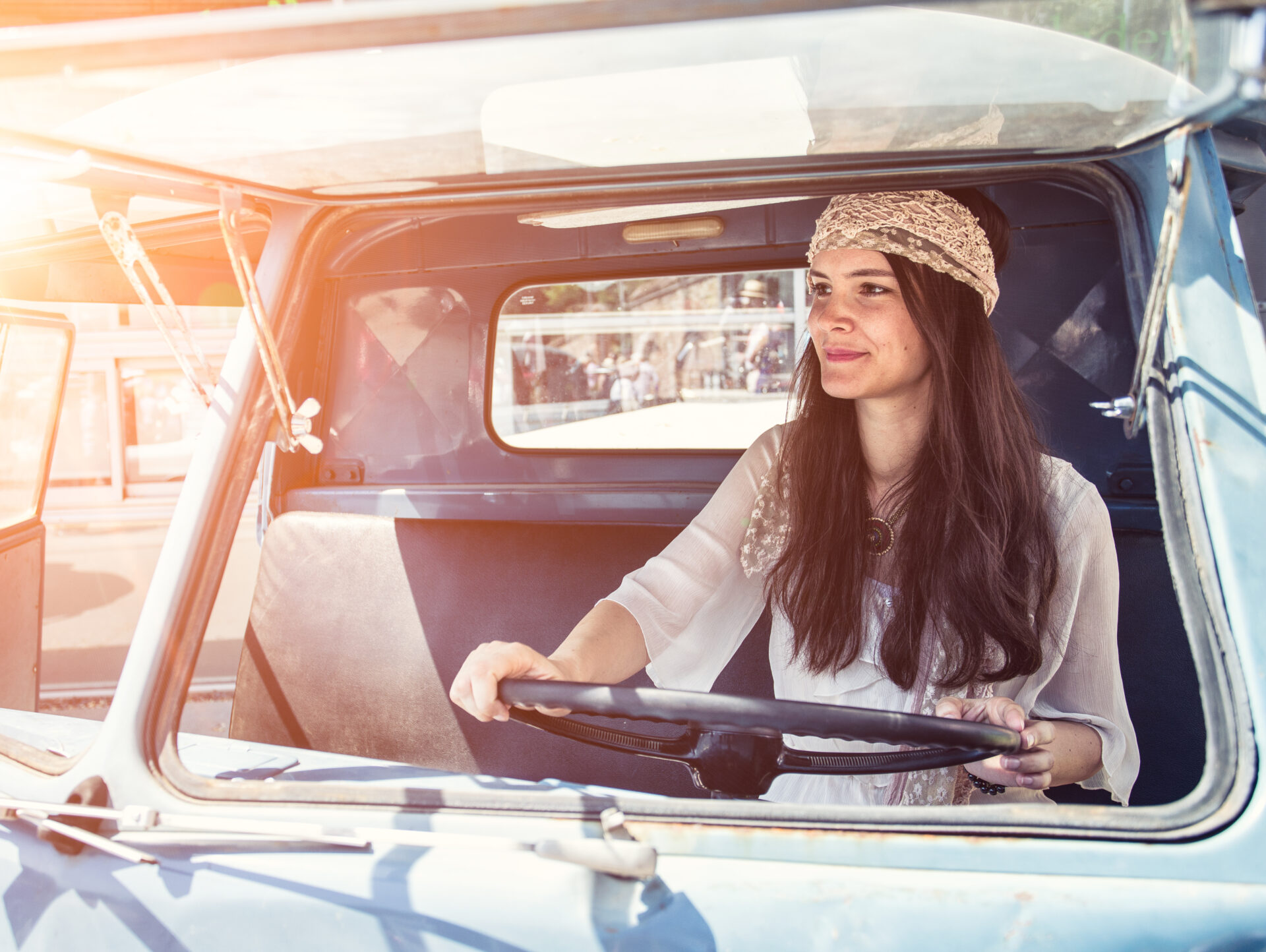 Pretty,young,hippie,woman,driving,her,vintage,oldtimer,car,(color